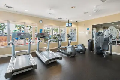 a gym with treadmills and elliptical machines at Luxury 3-bdr house with pool next to Disney in Orlando