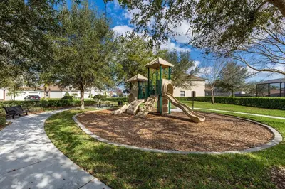 a playground in a park with a slide at Luxury 3-bdr house with pool next to Disney in Orlando