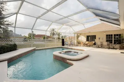 a swimming pool with a glassconservatory and a swimming poolvisor at New Listing Pool and Game Room 4BR in Orlando