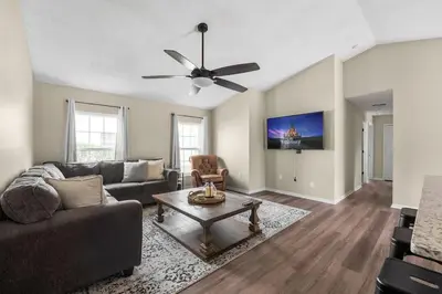 a living room with a couch and a ceiling fan at New Listing Pool and Game Room 4BR in Orlando