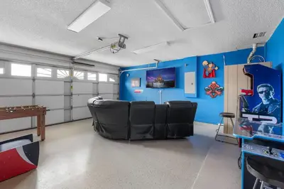 a room with blue walls and black chairs in a room at New Listing Pool and Game Room 4BR in Orlando