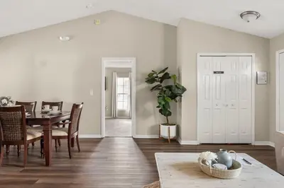 a living room with a table and a dining room at New Listing Pool and Game Room 4BR in Orlando