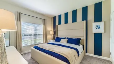 a bedroom with a bed with blue and white stripes at PEQ3141 in Kissimmee