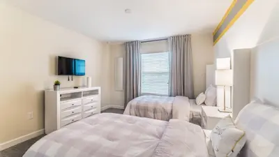 a bedroom with two beds and a tv at PEQ3141 in Kissimmee