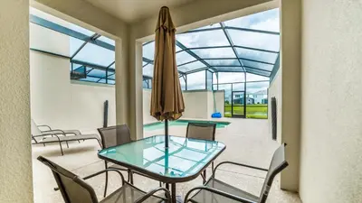 a dining room with a glass table and chairs at PEQ3141 in Kissimmee