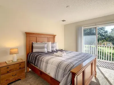 a bedroom with a large bed and a window at Spacious Emerald Escape - 12 Mins to Disney in Kissimmee