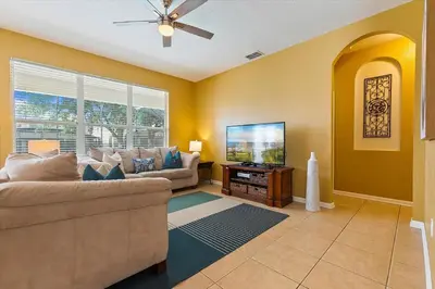 a living room with a couch and a flat screen tv at Windsor Hills Resort Vacation Home TS7718 in Orlando