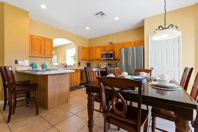 a kitchen with a wooden table and a dining room at Windsor Hills Resort Vacation Home TS7718 in Orlando