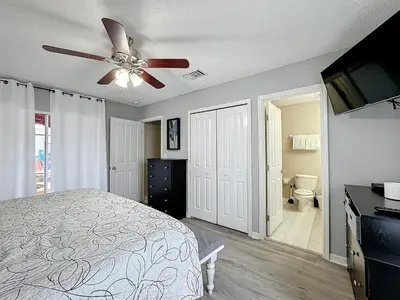 a bedroom with a bed and a ceiling fan at Stunning 5BR 5Bath Home, Pool, Spa, By Disney in Kissimmee