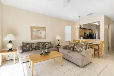 a living room with two couches and a table at Spacious Regal Oaks Retreat - Steps to the Pool in Orlando