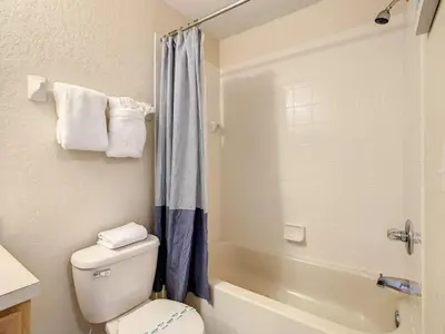 a bathroom with a white toilet and a shower at Spacious Regal Oaks Townhome by Disney in Orlando