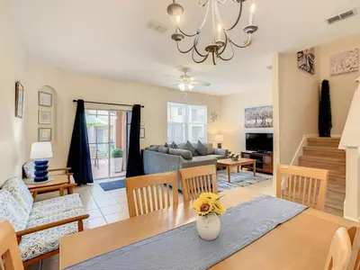 a dining room and living room with a table and chairs at Spacious Regal Oaks Townhome by Disney in Orlando