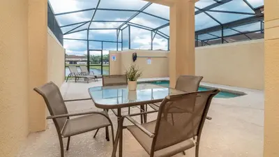 a dining room with a glass table and chairs at BCH3027 in Kissimmee