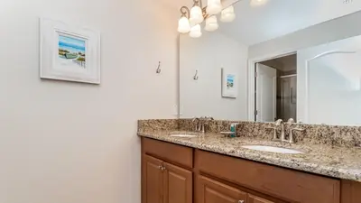 a bathroom with two sinks and a large mirror at BCH3027 in Kissimmee
