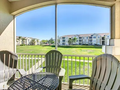 two chairs and a table on a balcony with a view at Spacious Windsor Palms Retreat - 11 Min to Disney in Kissimmee