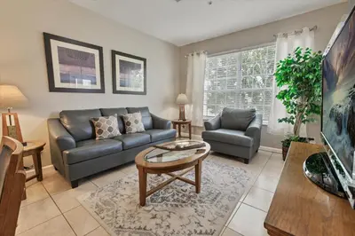 a living room with a couch and a table at CP8107-305 Windsor Palms Resort Vacation Condo in Orlando