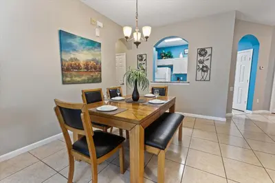 a dining room with a wooden table and chairs at CP8107-305 Windsor Palms Resort Vacation Condo in Orlando