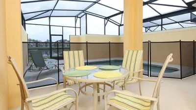 a patio with a table and chairs on a balcony at BCH3043 in Kissimmee