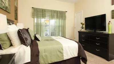 a bedroom with a bed and a flat screen tv at BCH3043 in Kissimmee