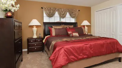 a bedroom with a bed and two lamps and a window at BCH3043 in Kissimmee