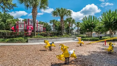 a playground with yellow toy dogs and a swing at CW7660-303 Windsor Hills Resort Vacation Condo in Orlando