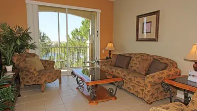 a living room with two couches and a balcony at CW7660-303 Windsor Hills Resort Vacation Condo in Orlando