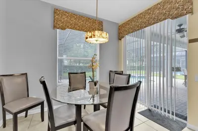 a dining room with a glass table and chairs at CW7713 Windsor Hills Resort Vacation Home in Orlando