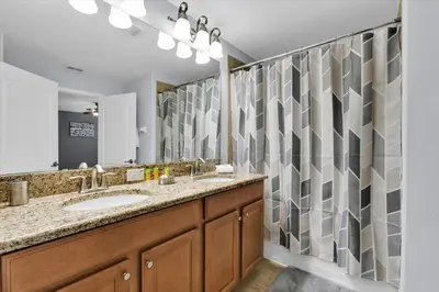 a bathroom with a sink and a large mirror at BCH3069 in Kissimmee