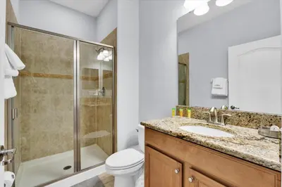 a bathroom with a shower and a toilet and a sink at BCH3069 in Kissimmee
