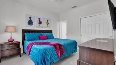 a bedroom with a bed and a dresser and a desk at CW7739 Windsor Hills Resort Vacation Home in Orlando