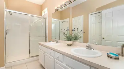 a bathroom with two sinks and a shower at CW7740 Windsor Hills Resort Vacation Home in Orlando