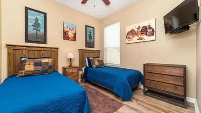 a bedroom with two beds and a flat screen tv at CW7740 Windsor Hills Resort Vacation Home in Orlando