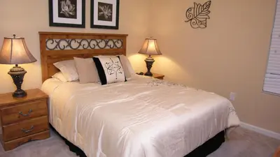 a bedroom with a large white bed with two lamps at DB2605 Windsor Hills Resort Vacation Home in Orlando