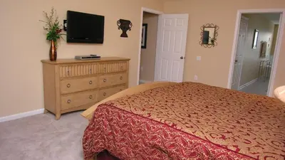a bedroom with a bed and a television on a dresser at DB2605 Windsor Hills Resort Vacation Home in Orlando