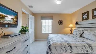 a bedroom with a large bed and a television at DB2605 Windsor Hills Resort Vacation Home in Orlando