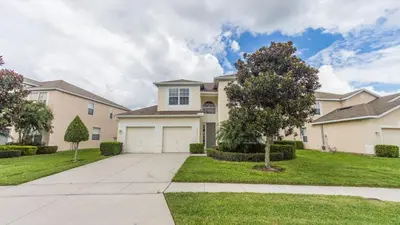 a large house with a driveway and grass at DB2633 Windsor Hills Resort Vacation Home in Orlando