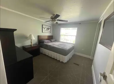 a bedroom with a bed and a ceiling fan at Agradable casa parqueos gratis in Orlando