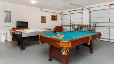 a room with two pool tables and a tv at BNC7795 in Orlando