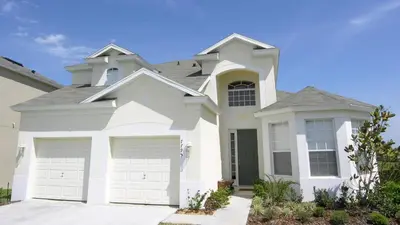 a white house with two garage doors at BNC7795 in Orlando
