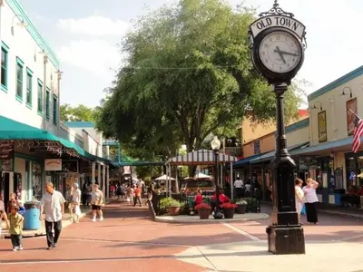 a clock on a pole on a street in a town at Stunning Regal Oaks 4BR w/ Pool, Spa & Near Disney in Orlando