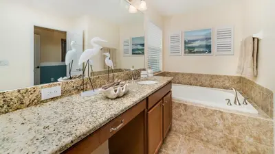a bathroom with a tub and a sink and two birds at BUC2979 in Kissimmee
