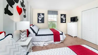 a bedroom with two beds and a dresser at BUC2979 in Kissimmee