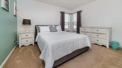 a bedroom with a bed and two dressers and a window at Windsor Palms Resort Vacation Home WP2243 in Kissimmee