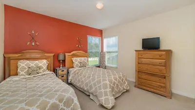 a bedroom with two beds and a tv in it at KP8038 Windsor Palms Resort Vacation Home in Kissimmee