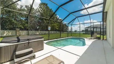 a swimming pool in a glass house with a patio at KP8038 Windsor Palms Resort Vacation Home in Kissimmee