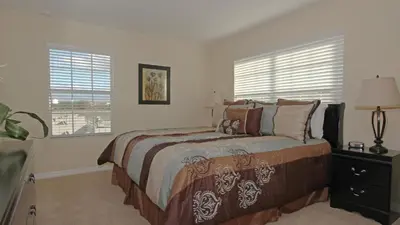 a bedroom with a bed and a window at CAL8967 in Kissimmee
