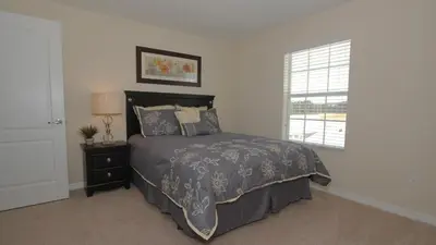 a bedroom with a bed and a window at CAL8967 in Kissimmee