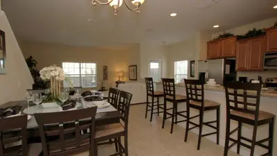 a kitchen and dining room with a table and chairs at CAL8967 in Kissimmee