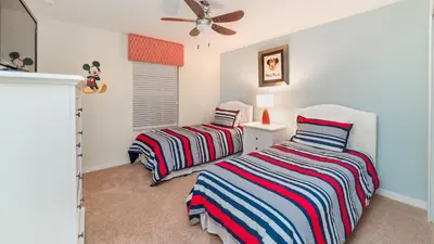 a bedroom with two beds and a ceiling fan at CAP8875 in Kissimmee