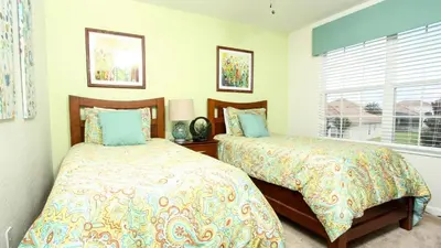 a bedroom with two beds and a window at Luxury 6 BR in Windsor Hill Resorts in Orlando